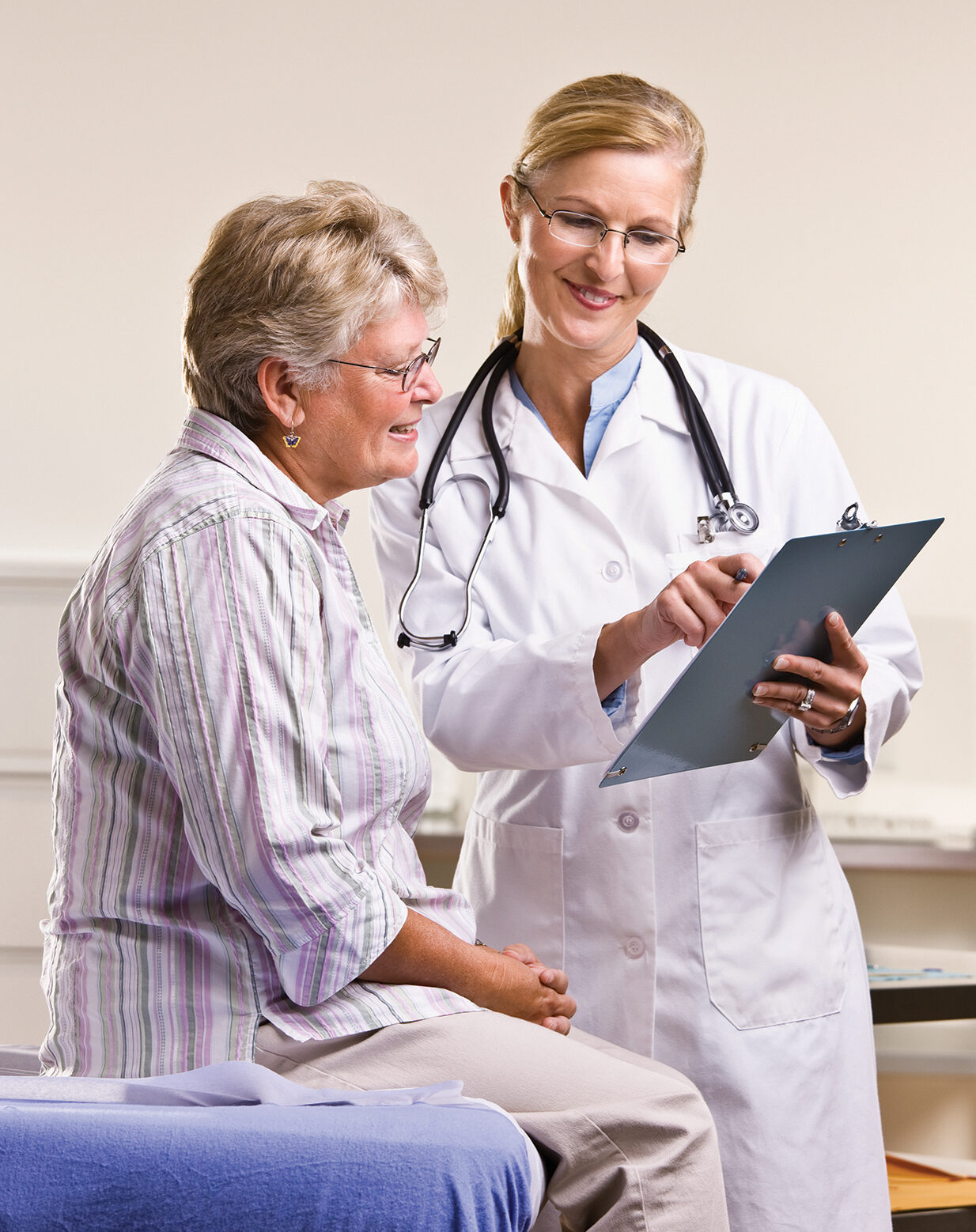 Doctor explaining medical chart to senior woman